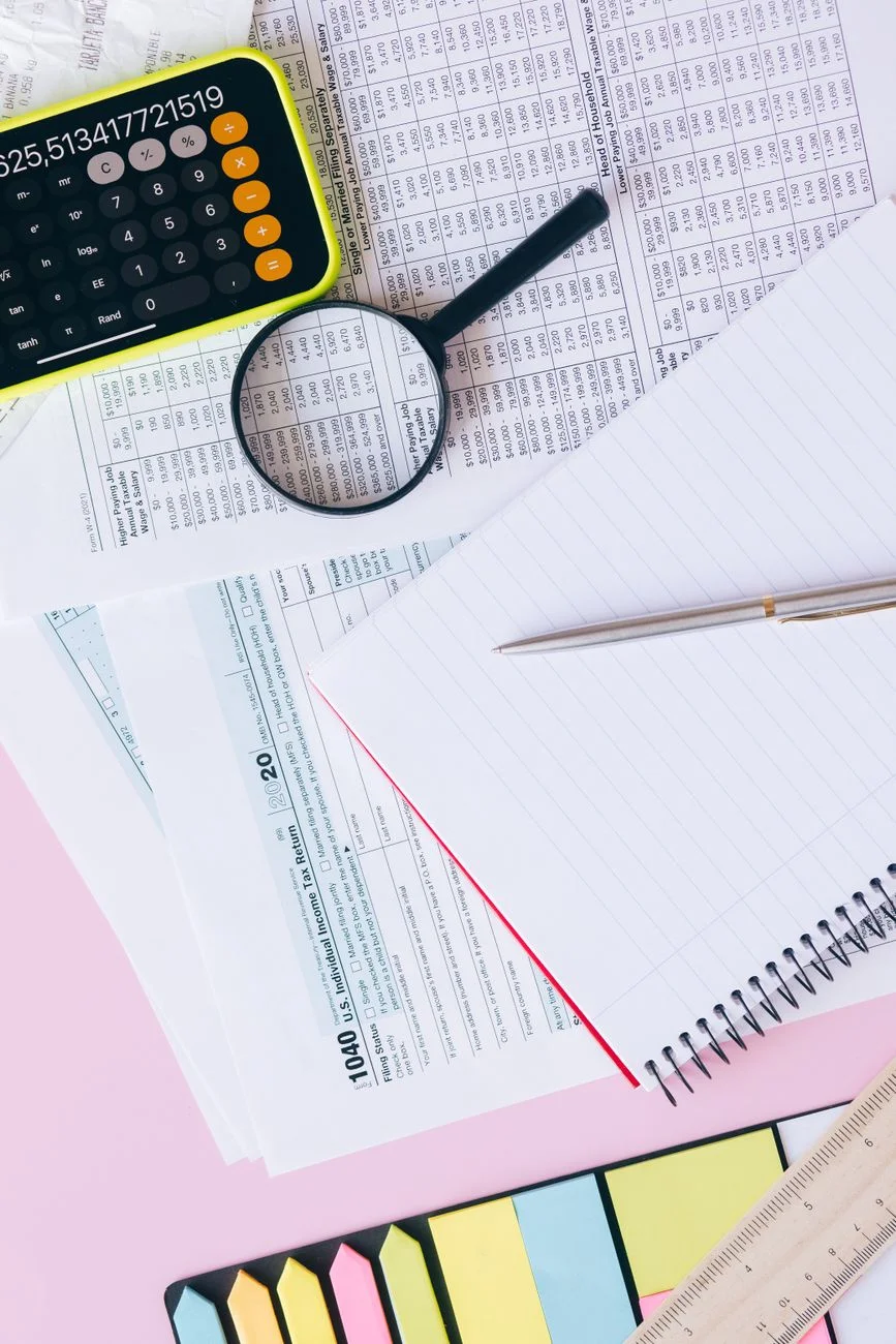 Calculator and tax documents on a desk representing contractor rate planning