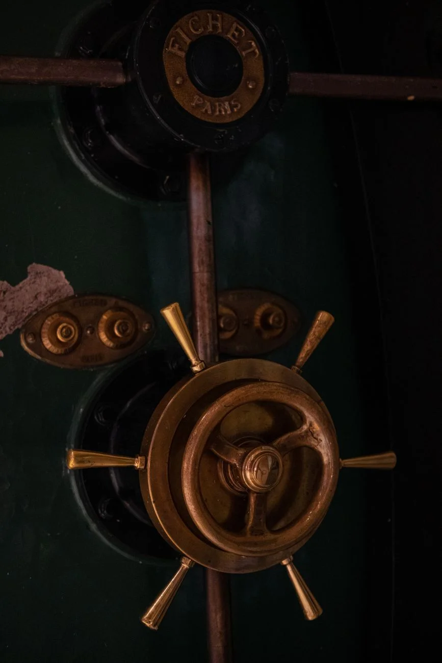Heavy bank vault door standing open in a bank interior
