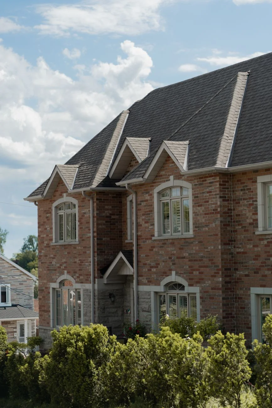 A suburban house exterior in daylight representing a home covered by a homeowners insurance policy