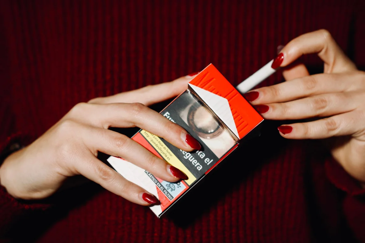 A pack of cigarettes with a price sticker representing the visible cost of smoking