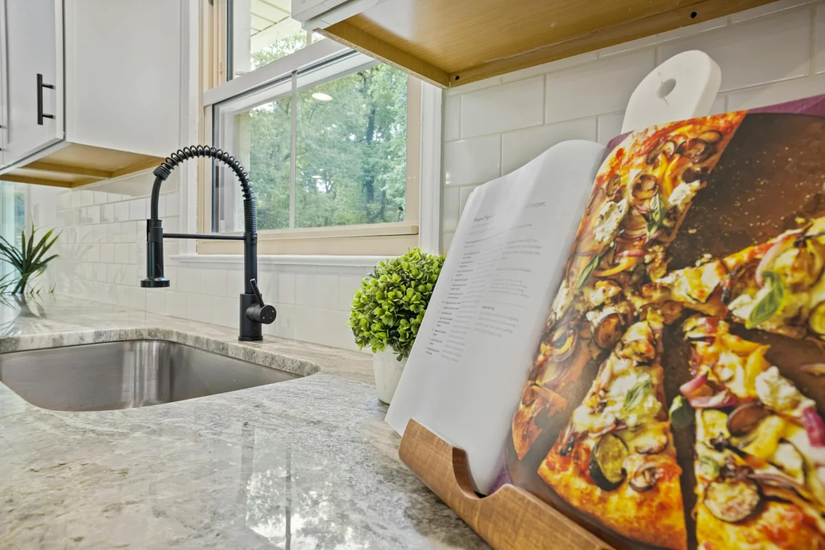 A renovated kitchen with new white countertops and updated cabinetry