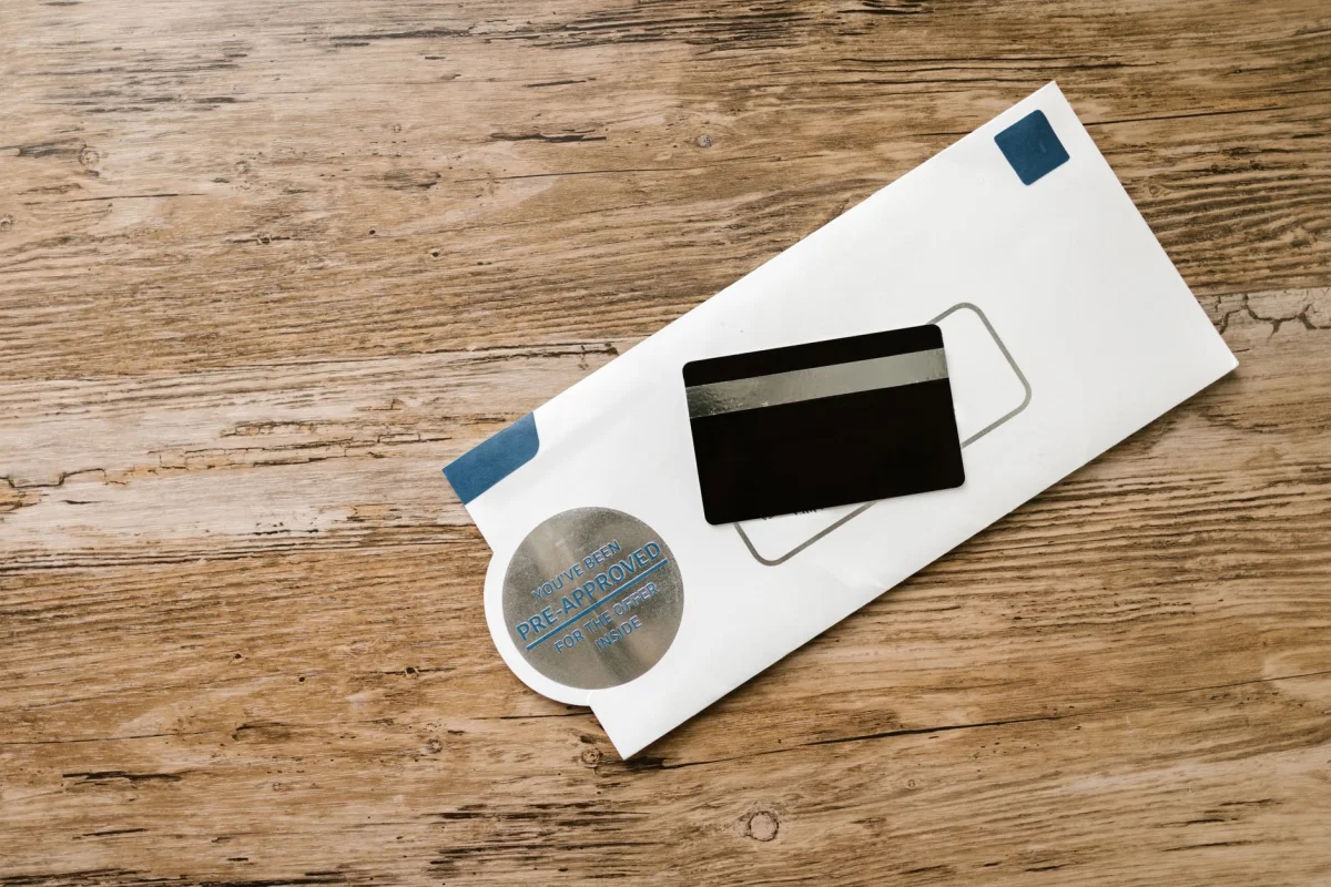 A paper credit card statement and an envelope on a kitchen table