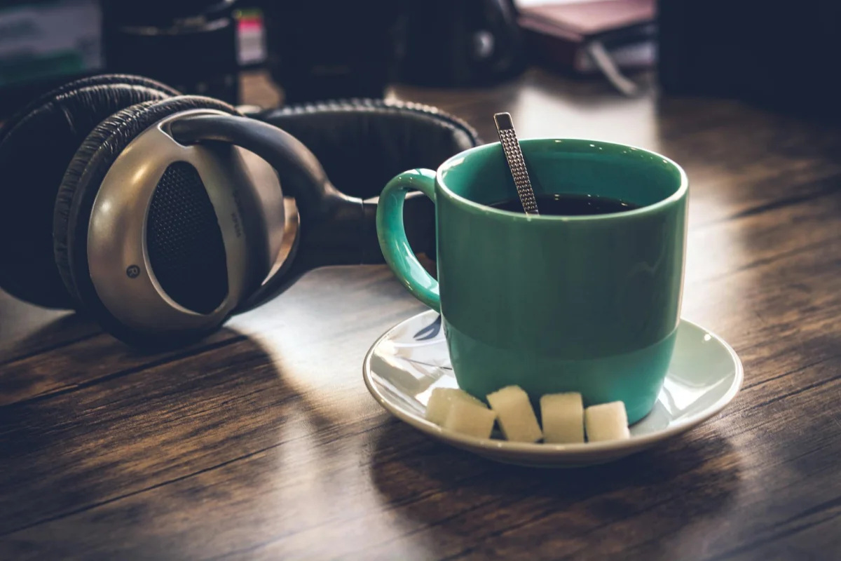 A close-up of a coffee cup on a desk in the morning light
