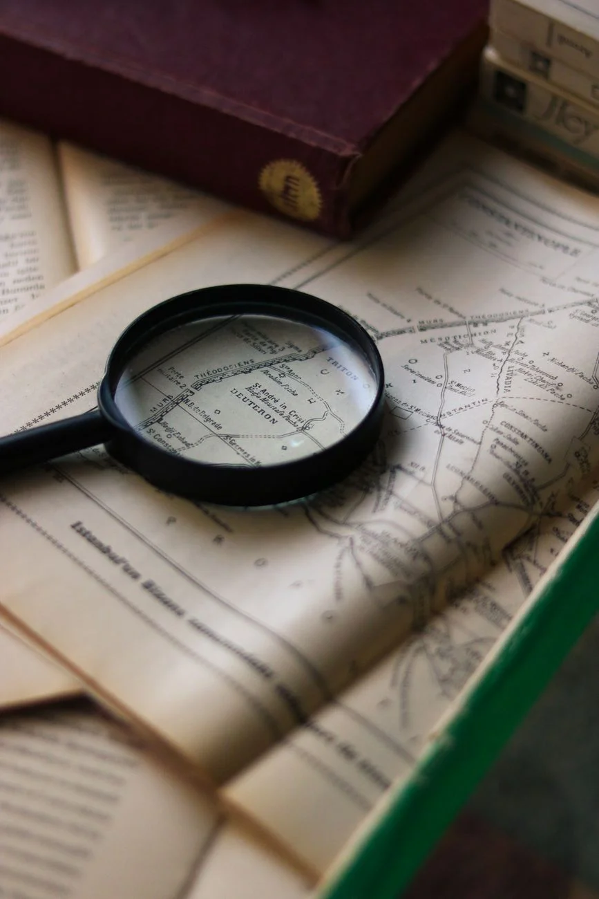 A magnifying glass resting on a printed document as if reviewing it line by line