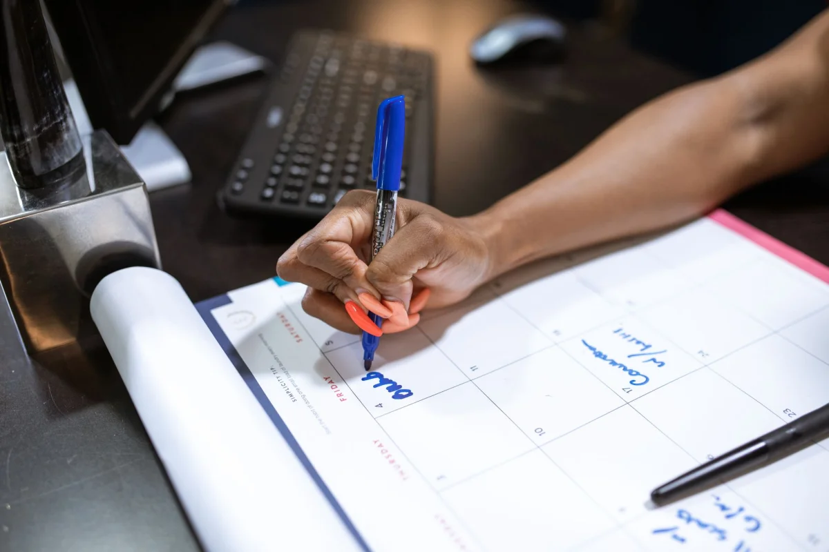 planner and calculator on a wooden desk used to compare compensation numbers