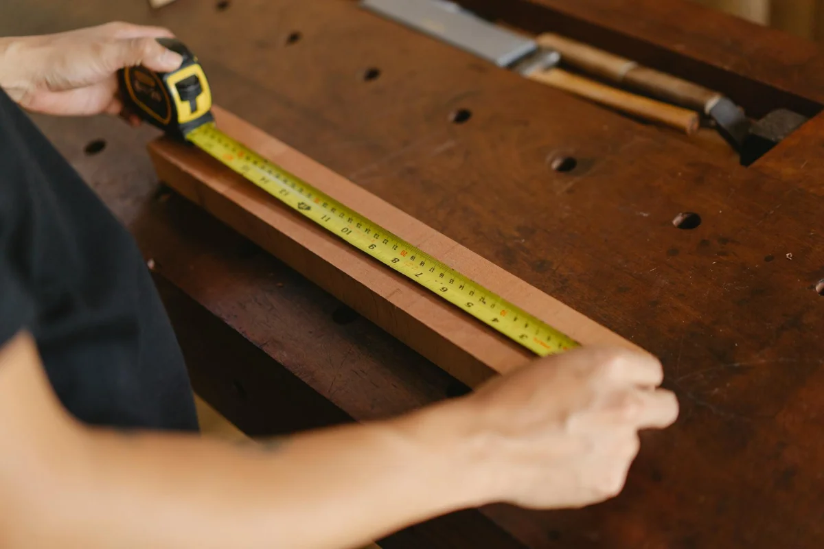 Measuring tape and ruler laid out on a workshop bench