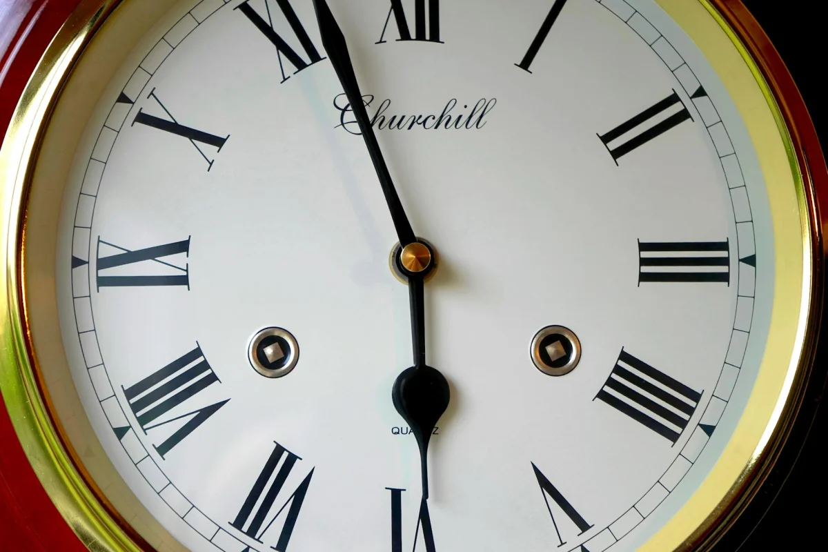 Close-up of a wall clock face with bold numerals