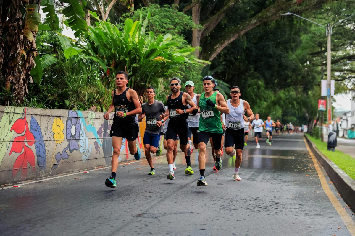 Marathon runners competing on a wet urban road course