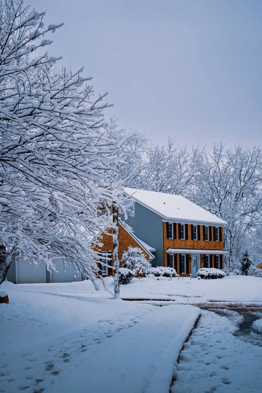 A portable generator running outside a home during a storm with cables connected
