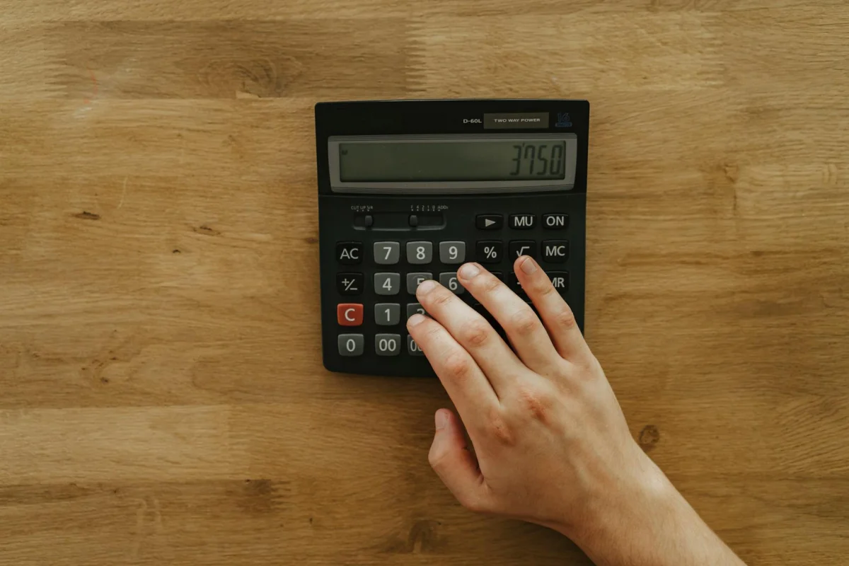 Calculator and retirement planning documents on a desk