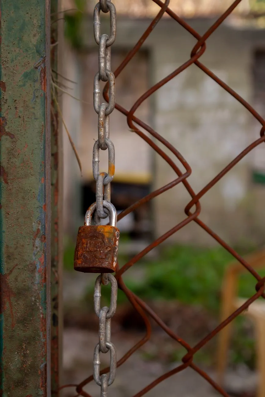 A heavy padlock and chain on a weathered metal surface representing integrity verification