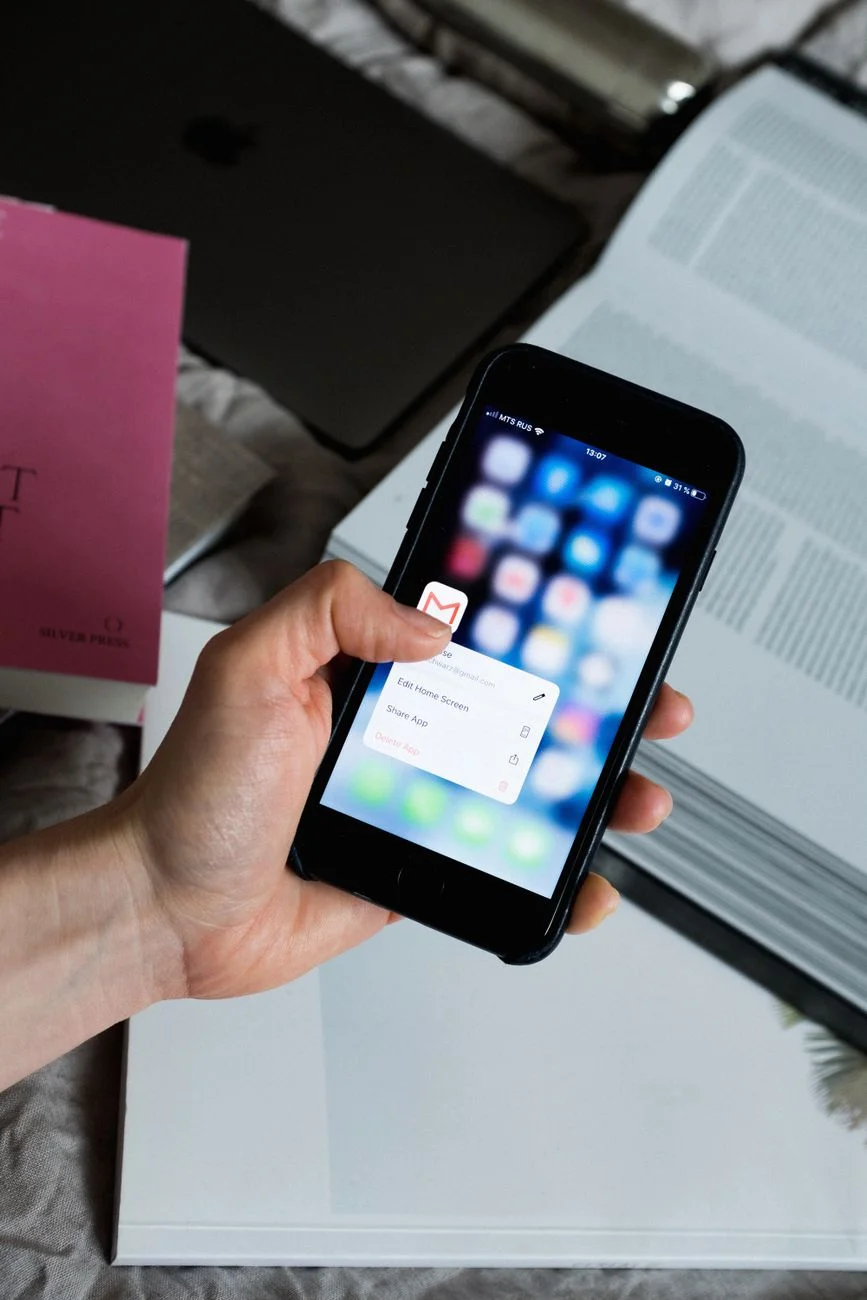 Person scrolling through email inbox on smartphone