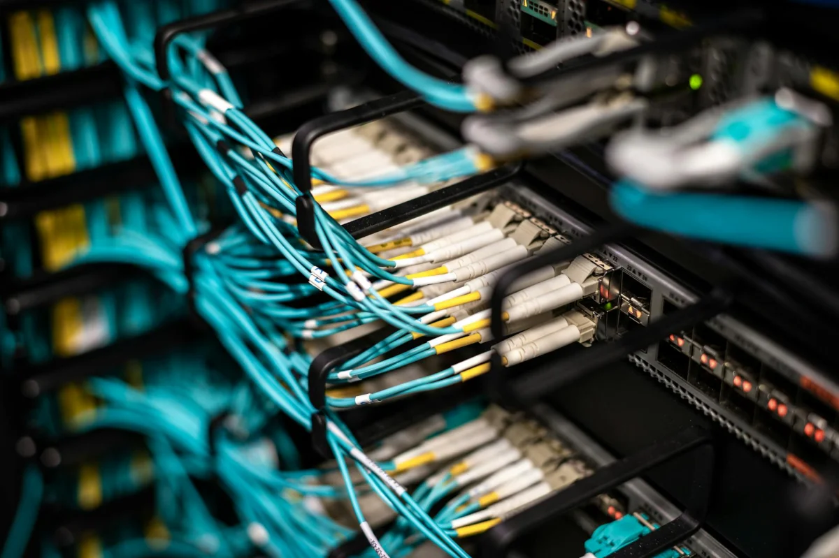 Server rack with organized network cables in a data center corridor