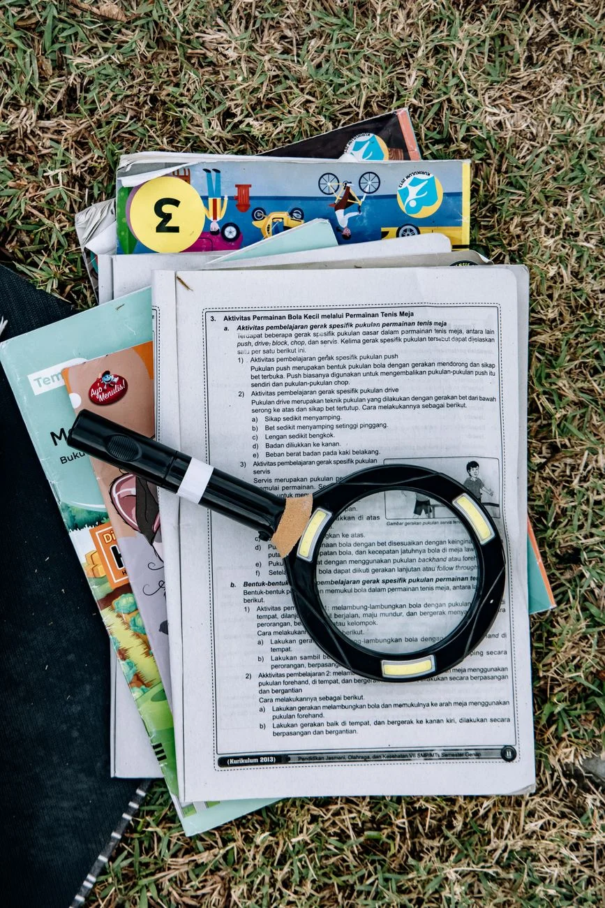 Magnifying glass held over printed text, representing searching for a pattern within a larger document