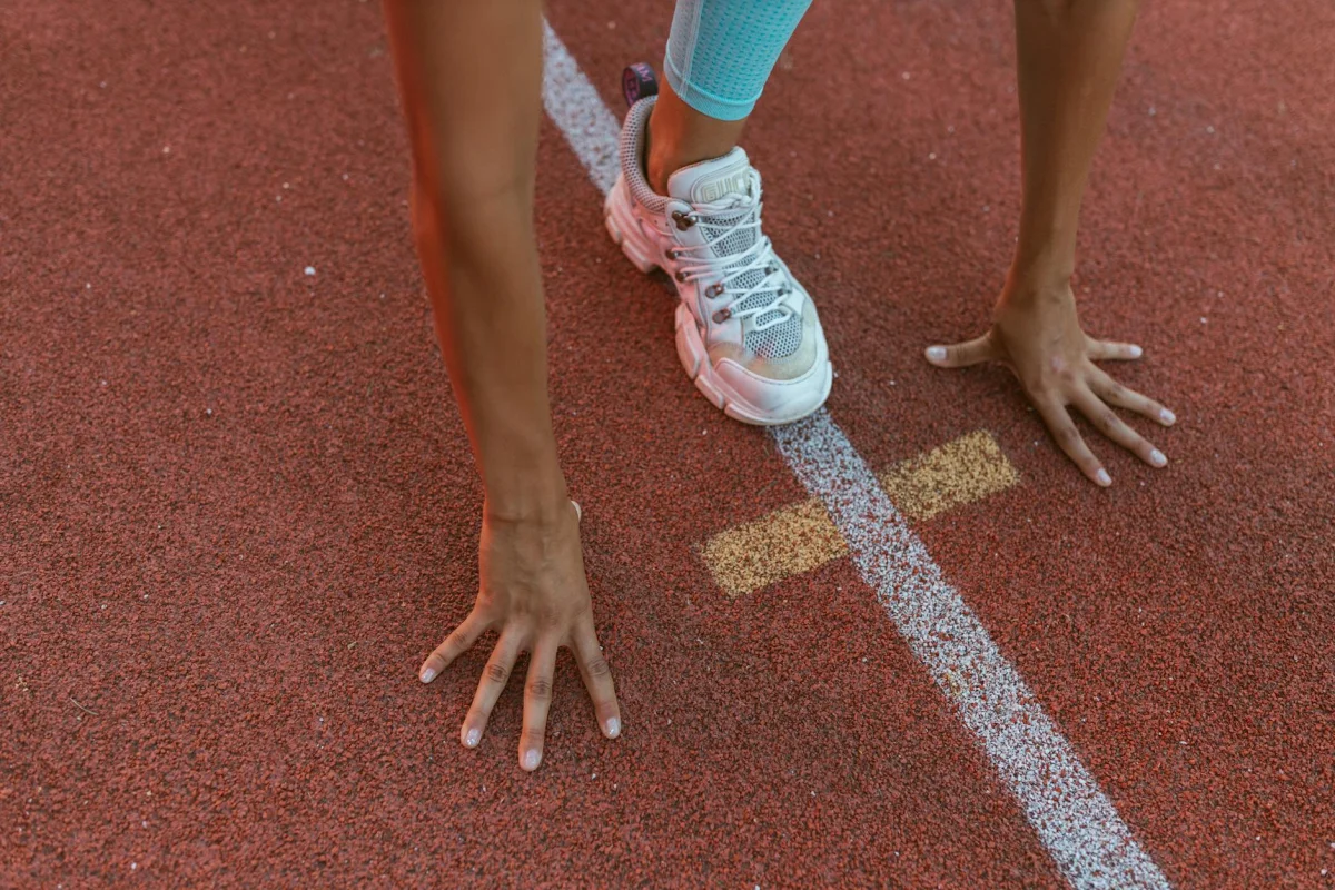 Runners lined up at the starting line of a track race
