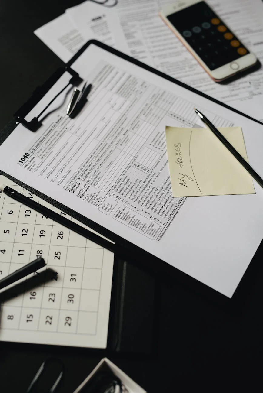 Tax forms and a calculator on a desk representing retirement account planning