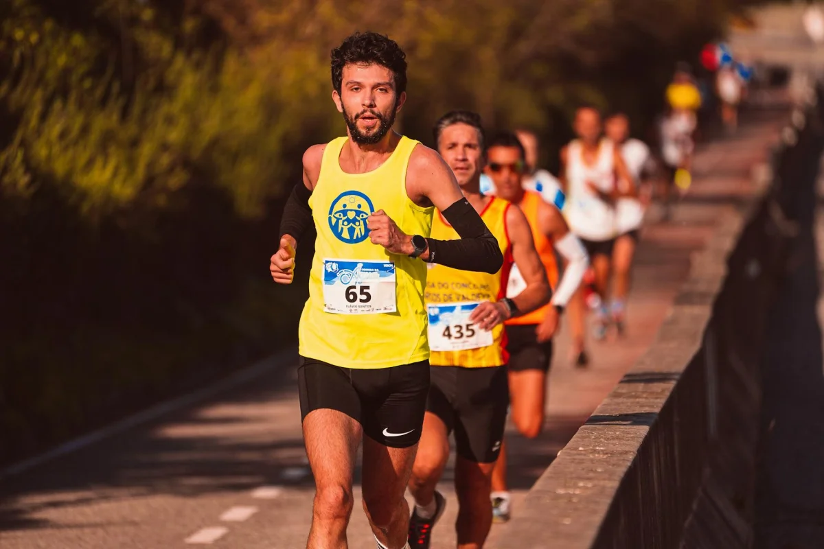 Runner on a road race track with focus on form and pace during training