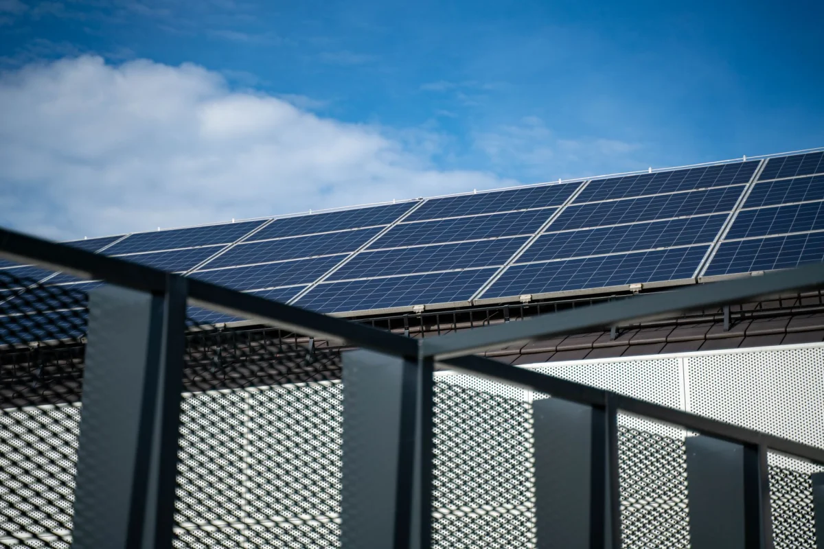Solar panels mounted on a residential rooftop under a clear sky
