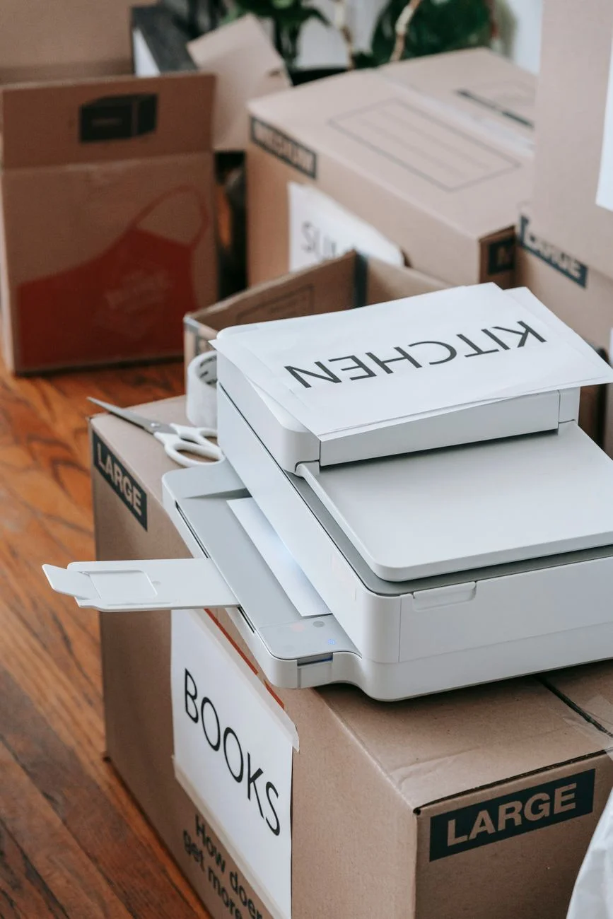 Packed cardboard boxes on a quiet office desk after someone has left a job