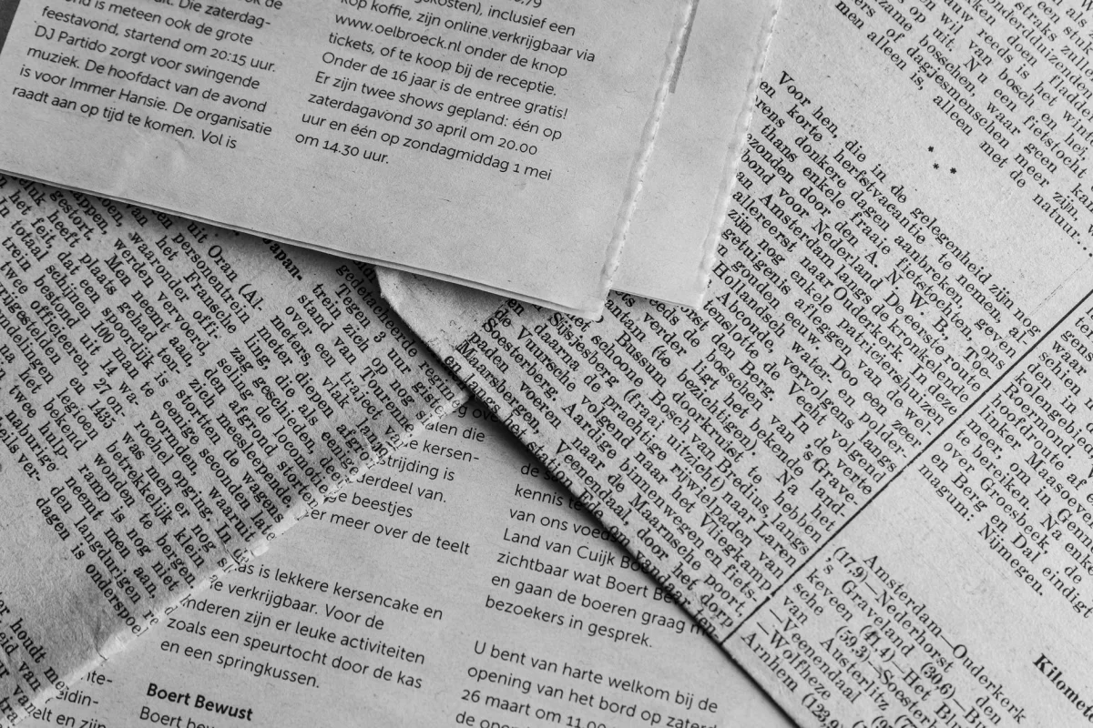 Rows of bold newspaper headlines in print, representing headline writing and analysis