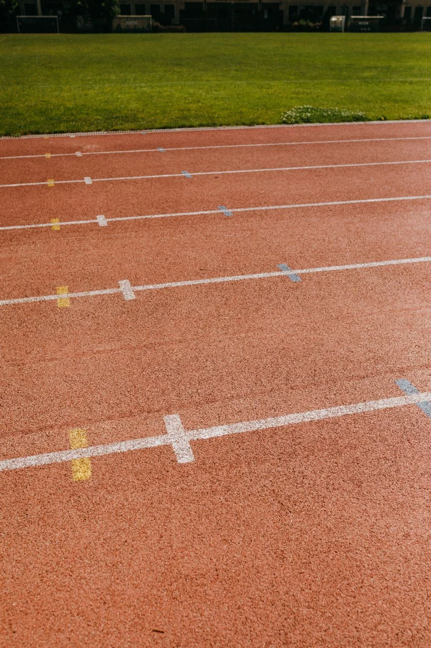Runner on an outdoor track representing aerobic fitness testing