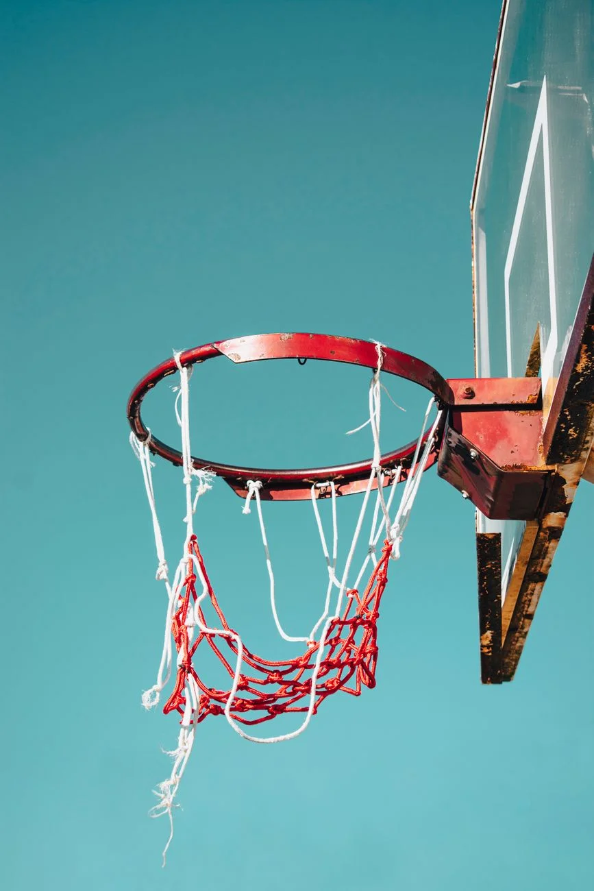 A basketball captured mid-arc during a shot, a real-world example of a parabolic trajectory