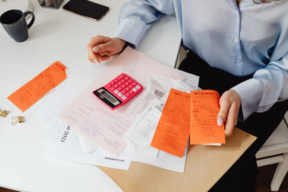 A calculator and loan paperwork laid out on a kitchen table