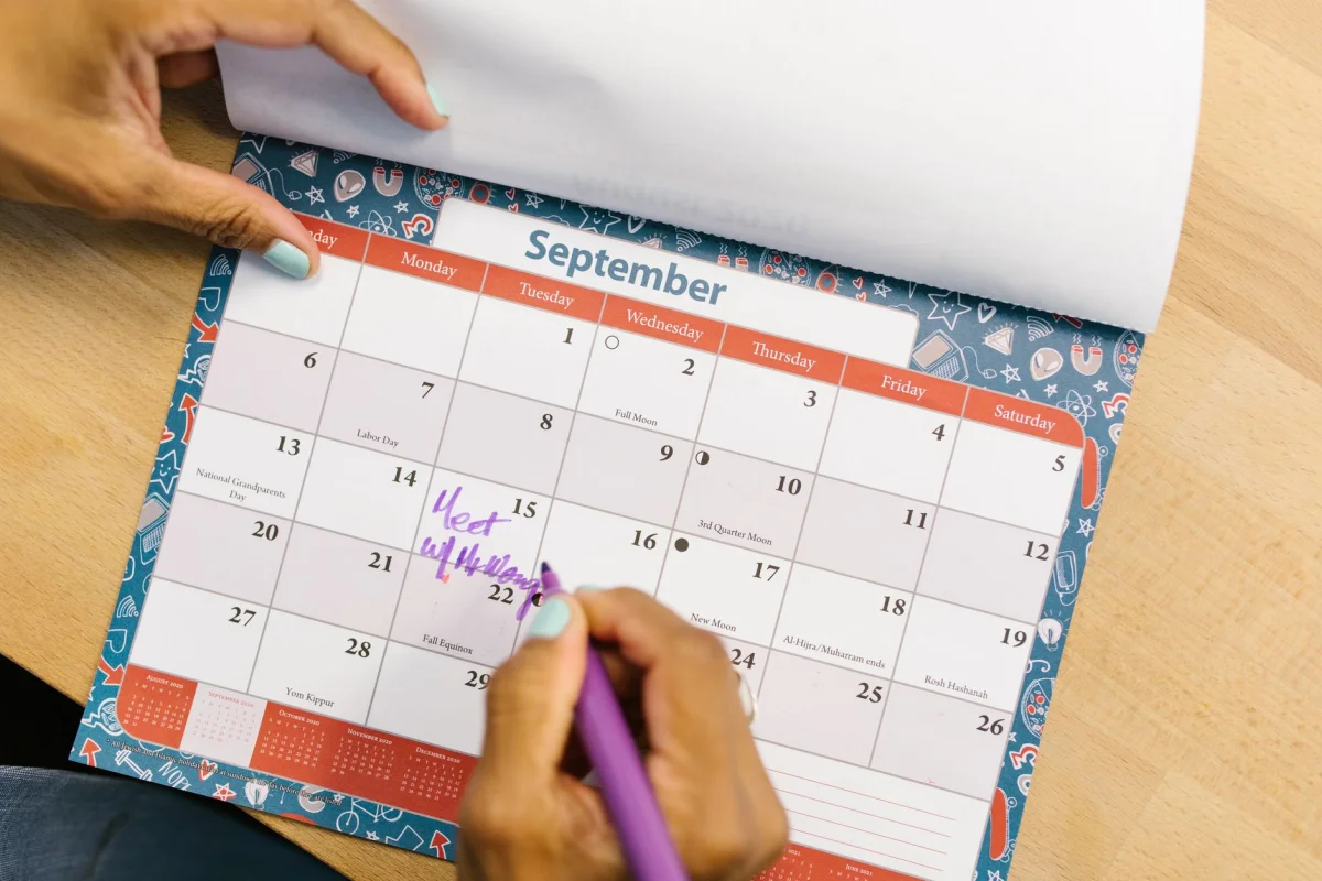 A wall calendar with several dates circled, representing tracking days between two dates