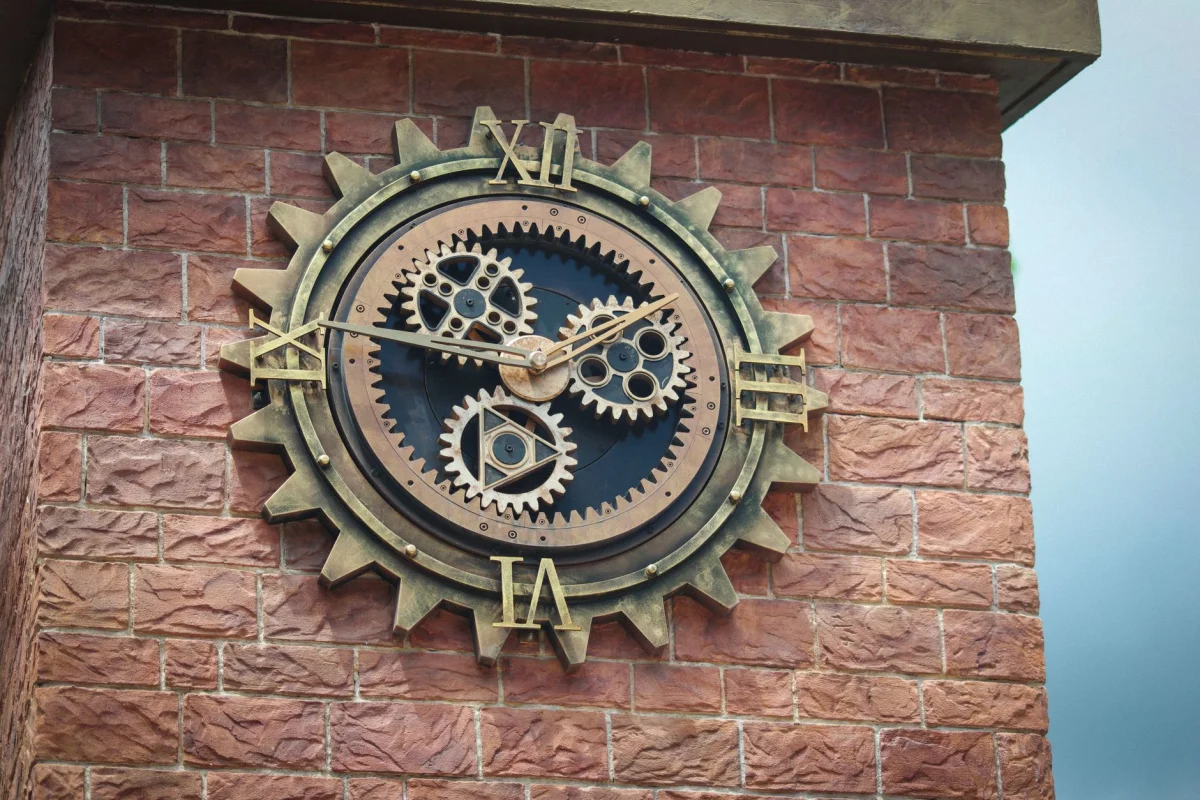 Close view of a mechanical wall clock face showing the minute and hour hands