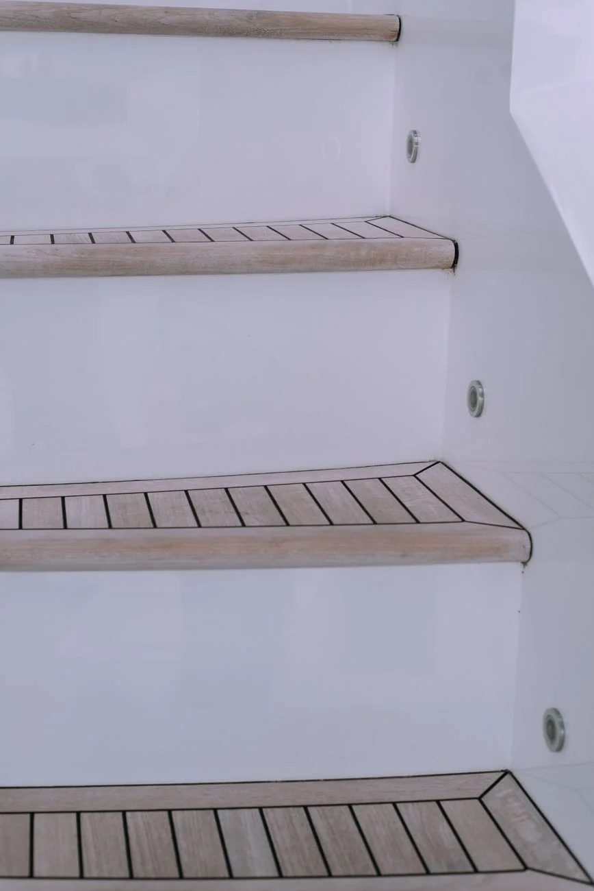 A wooden staircase frame mid-construction showing exposed stringers and open risers