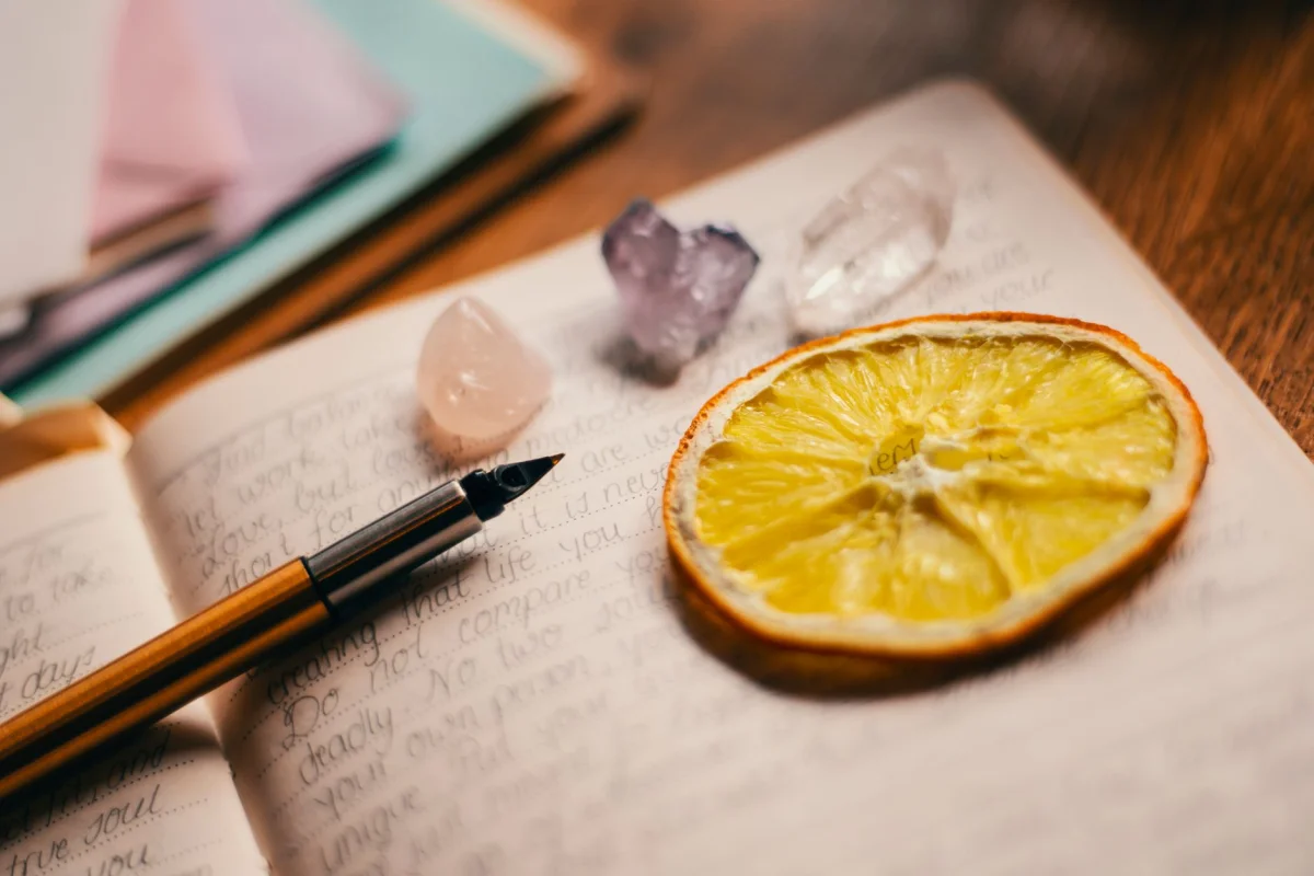 An open notebook with a fountain pen resting on a draft page covered in handwritten edits