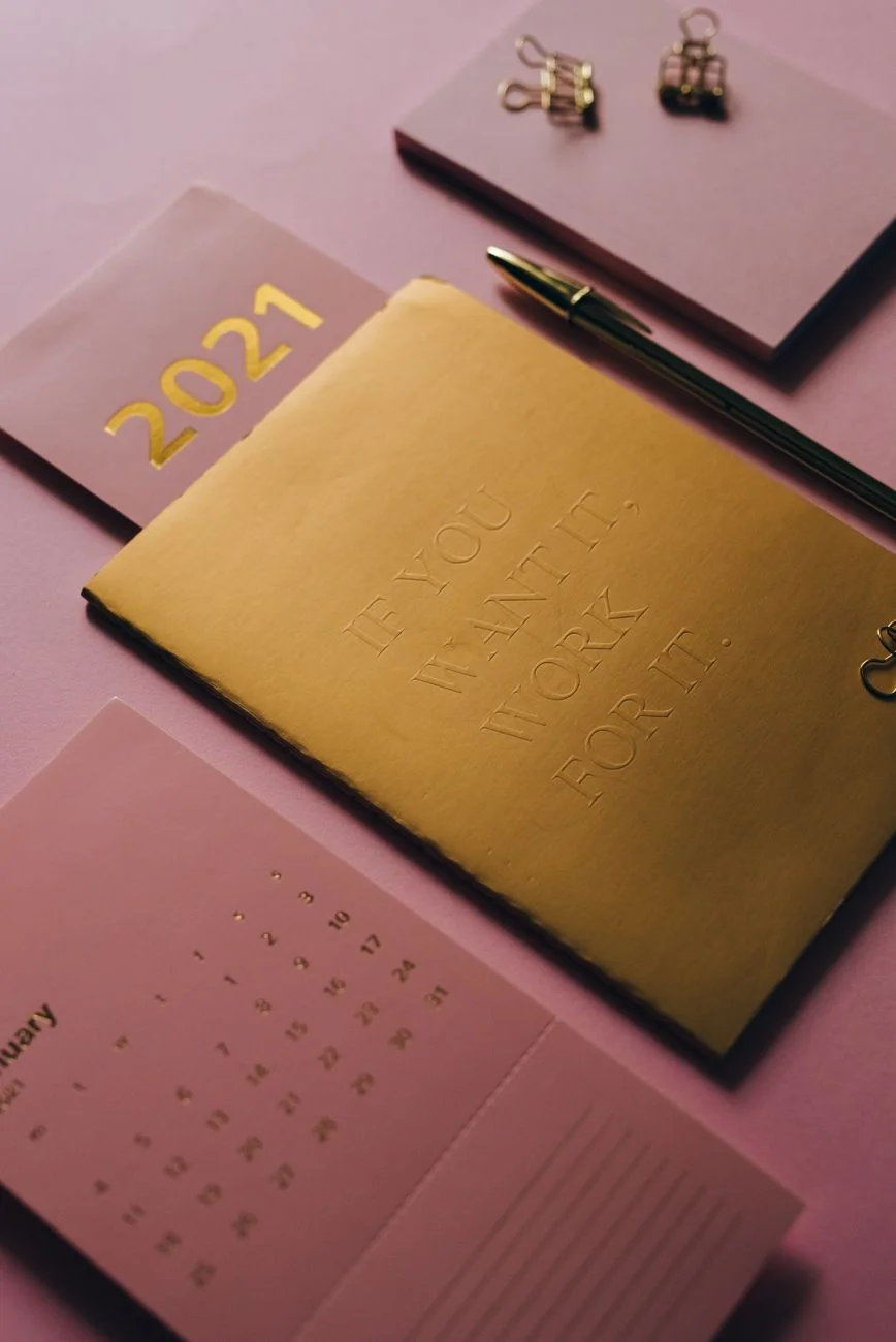 A wall calendar with one date circled in red pen above a tidy desk