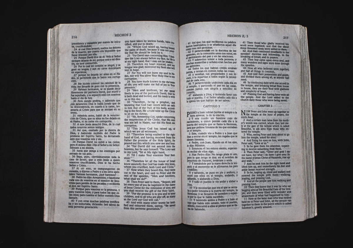 Two printed pages laid side by side on a desk with edits circled in pen