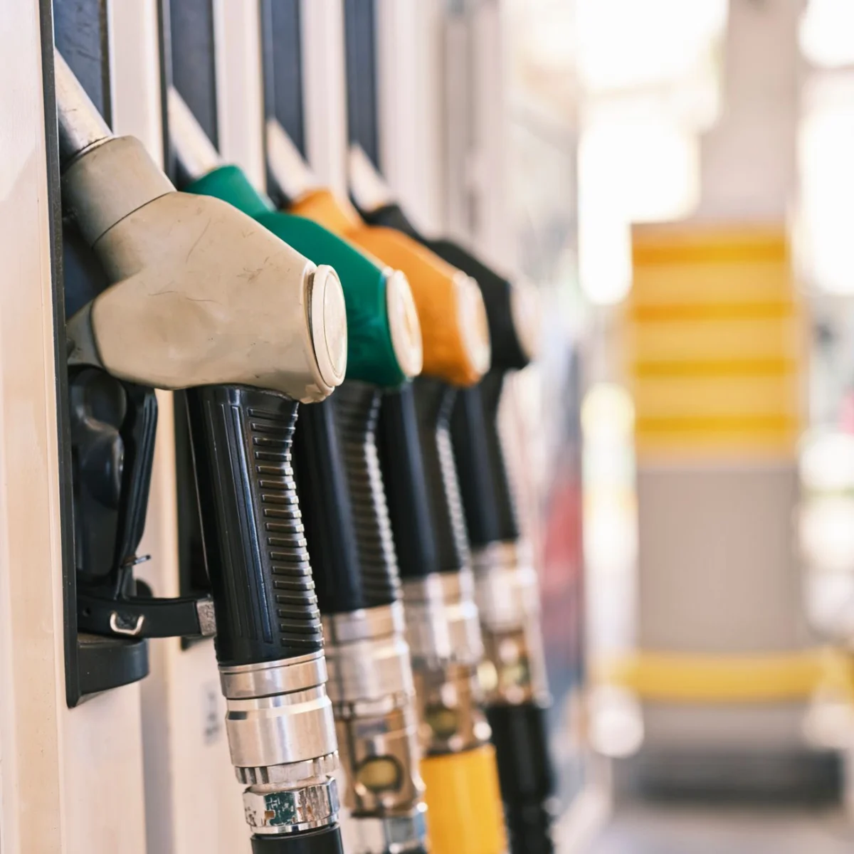 Close-up of a fuel pump nozzle at a gas station