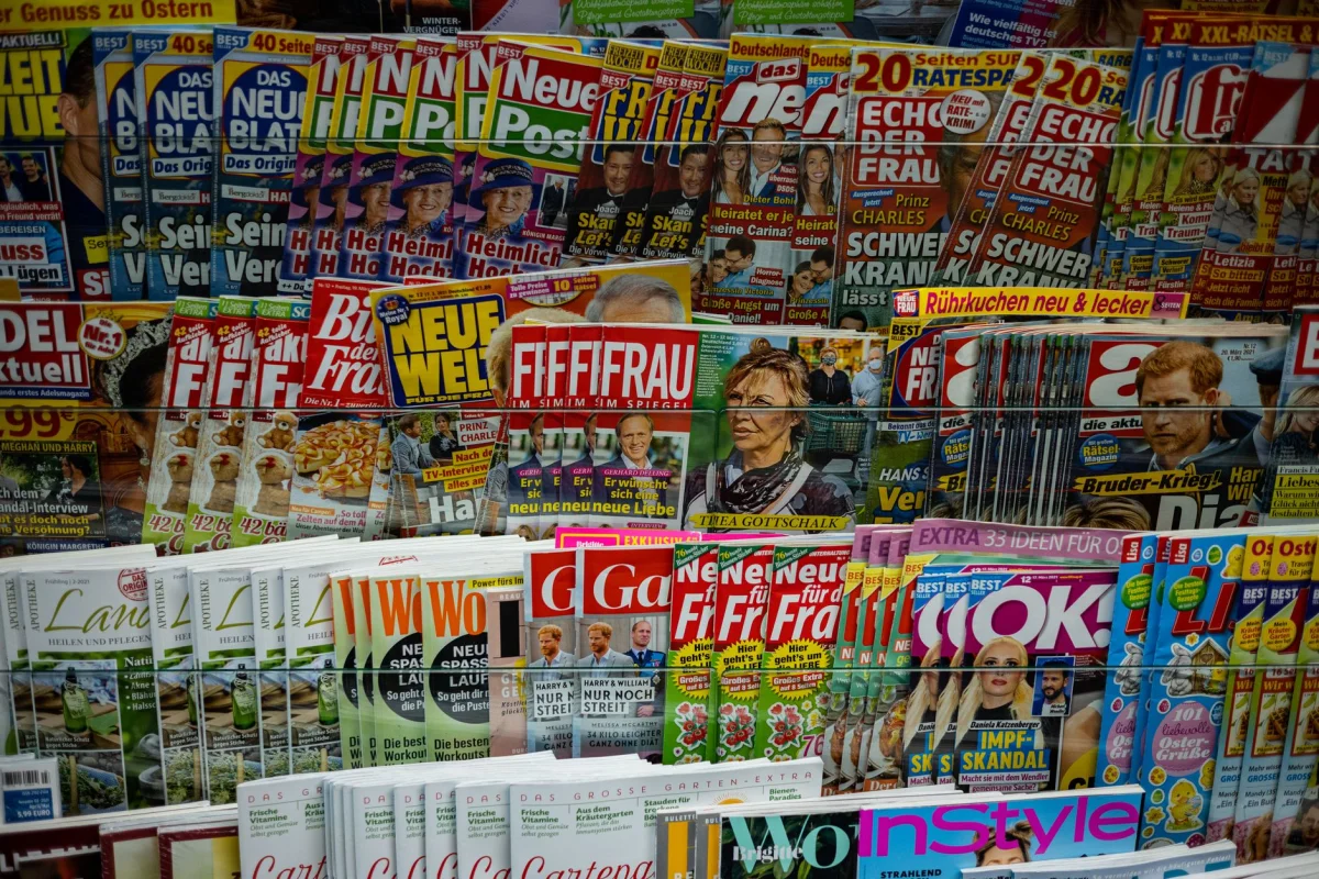 Newsstand display packed with magazines and newspapers