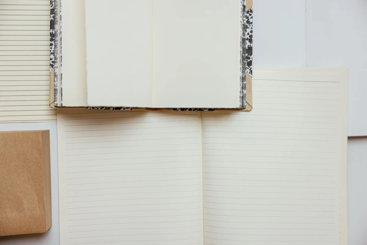 An open notebook with handwritten pages representing drafting and formatting written content